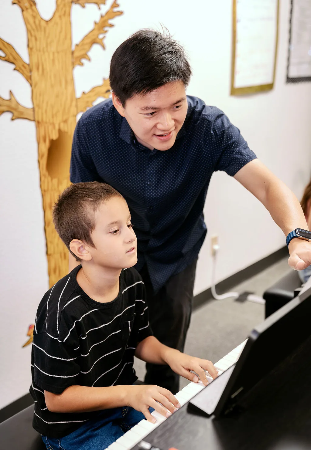 A teacher guiding a student through a one-on-one lesson.
