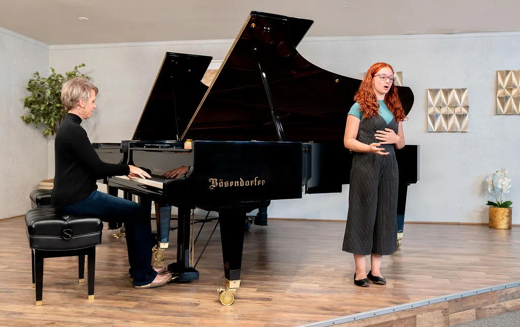 A voice student performing with a piano accompanist.
