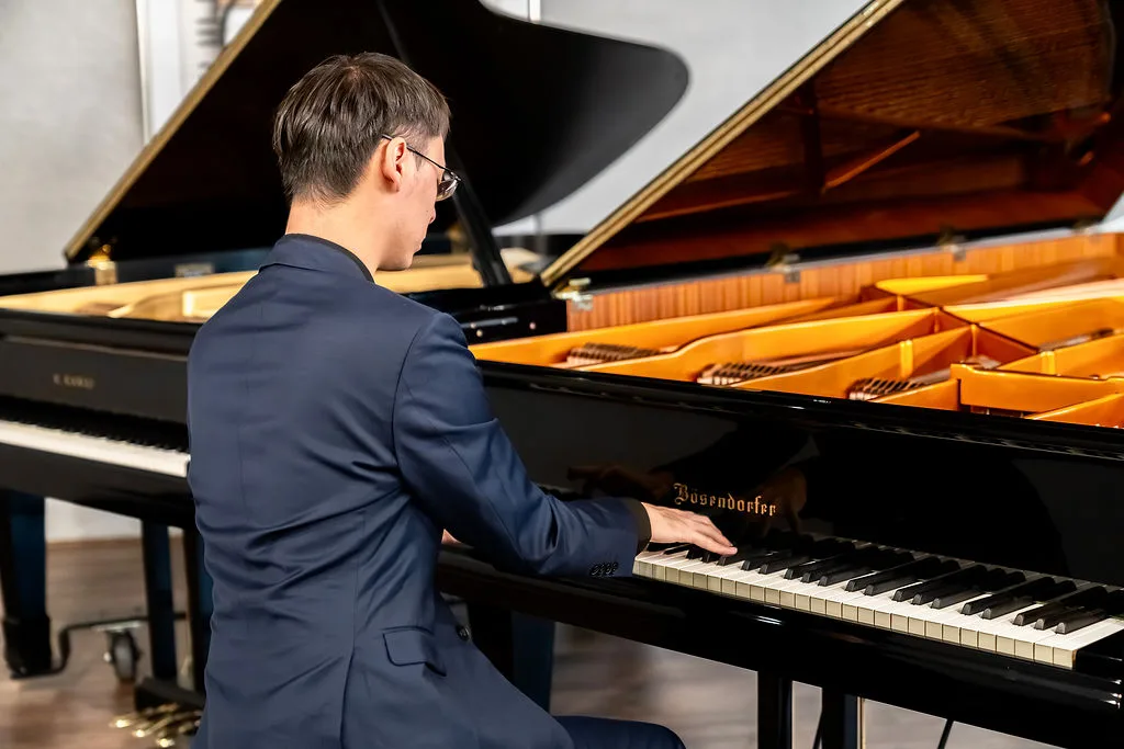 An advanced student performing at the grand piano.